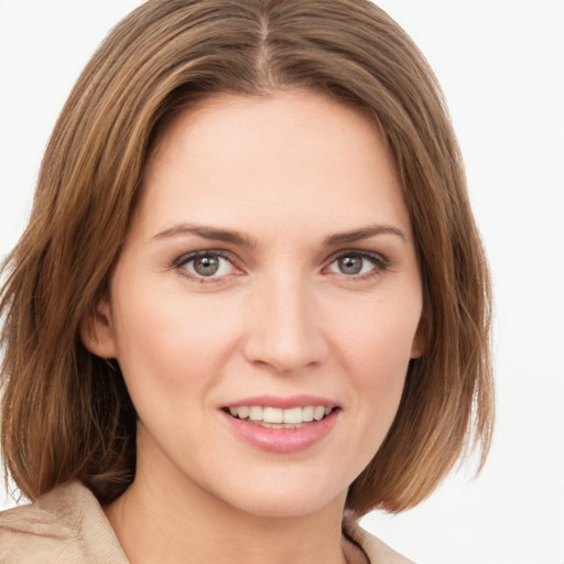 Joyful white young-adult female with medium  brown hair and green eyes