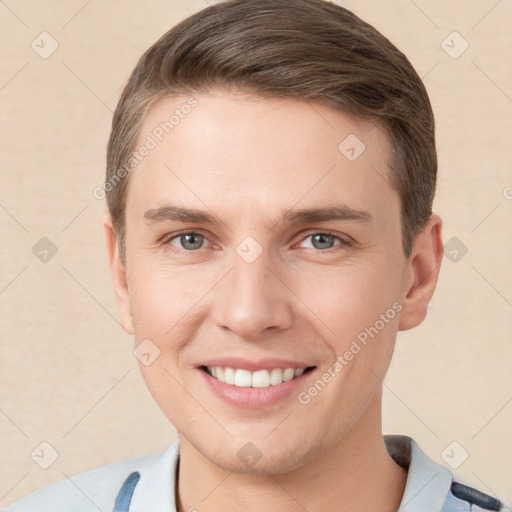 Joyful white young-adult male with short  brown hair and grey eyes