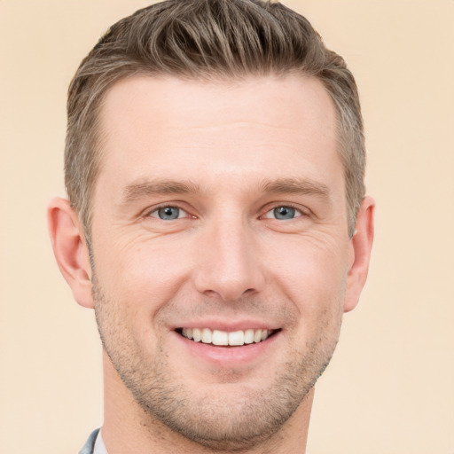 Joyful white young-adult male with short  brown hair and grey eyes