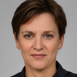 Joyful white adult female with short  brown hair and grey eyes