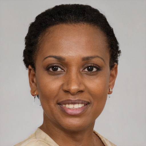 Joyful black adult female with short  brown hair and brown eyes