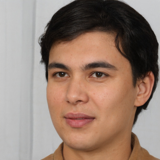 Joyful latino young-adult male with short  brown hair and brown eyes