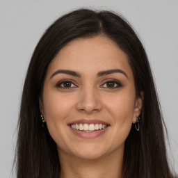 Joyful white young-adult female with long  brown hair and brown eyes