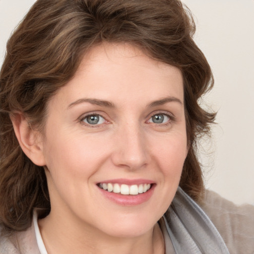 Joyful white young-adult female with medium  brown hair and blue eyes