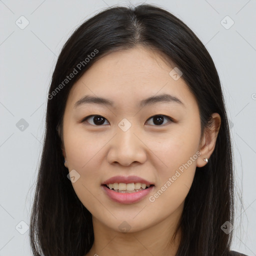 Joyful asian young-adult female with long  brown hair and brown eyes