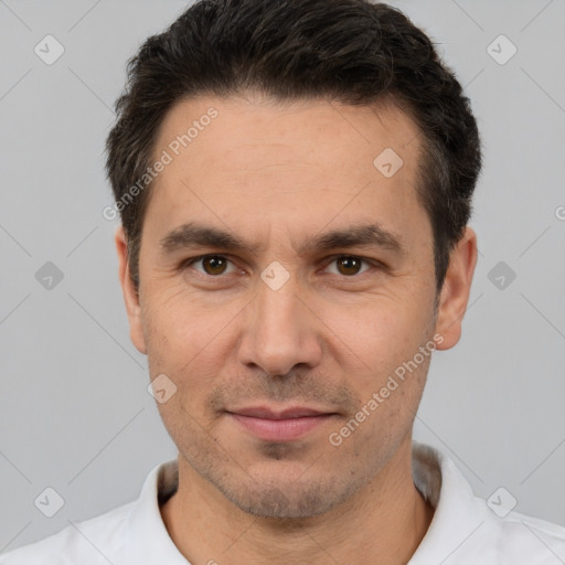 Joyful white adult male with short  black hair and brown eyes