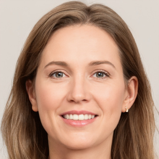 Joyful white young-adult female with long  brown hair and grey eyes