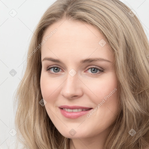 Joyful white young-adult female with long  brown hair and blue eyes