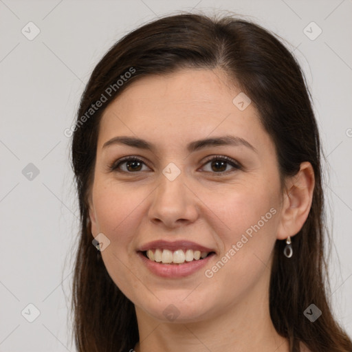 Joyful white young-adult female with long  brown hair and brown eyes