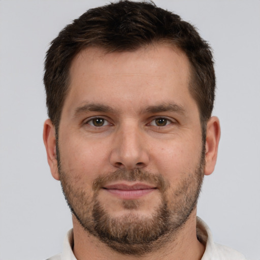 Joyful white young-adult male with short  brown hair and brown eyes