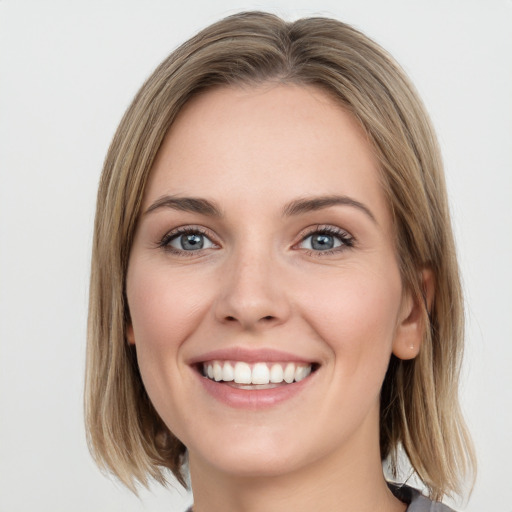 Joyful white young-adult female with medium  brown hair and blue eyes