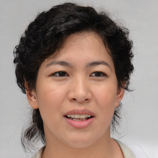 Joyful asian young-adult female with medium  brown hair and brown eyes