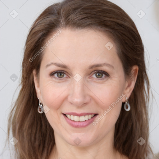 Joyful white adult female with long  brown hair and grey eyes