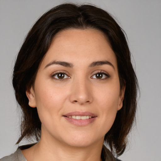 Joyful white young-adult female with medium  brown hair and brown eyes