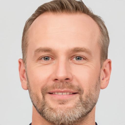 Joyful white adult male with short  brown hair and grey eyes