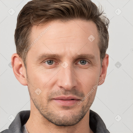 Joyful white adult male with short  brown hair and grey eyes