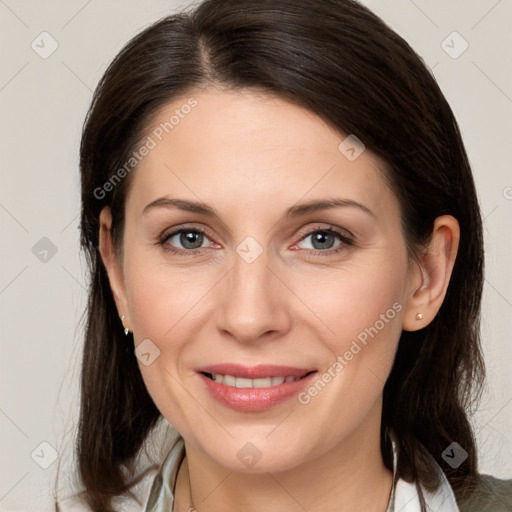 Joyful white adult female with medium  brown hair and brown eyes