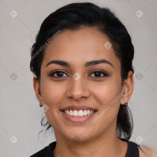 Joyful latino young-adult female with medium  brown hair and brown eyes