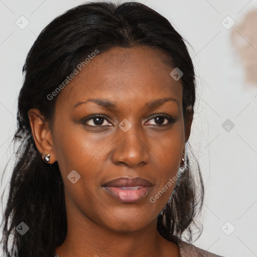 Joyful black young-adult female with long  brown hair and brown eyes