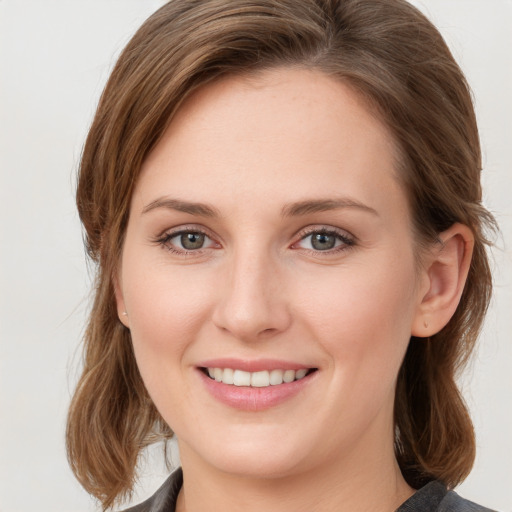 Joyful white young-adult female with medium  brown hair and blue eyes