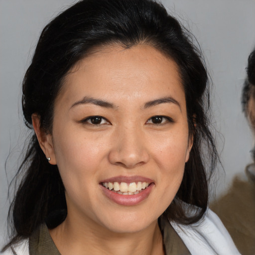 Joyful asian young-adult female with medium  brown hair and brown eyes