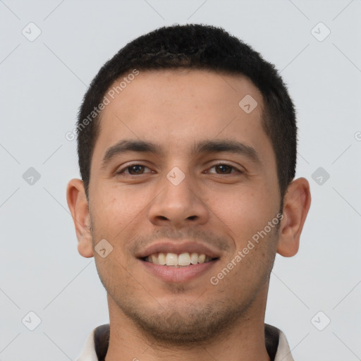 Joyful latino young-adult male with short  brown hair and brown eyes