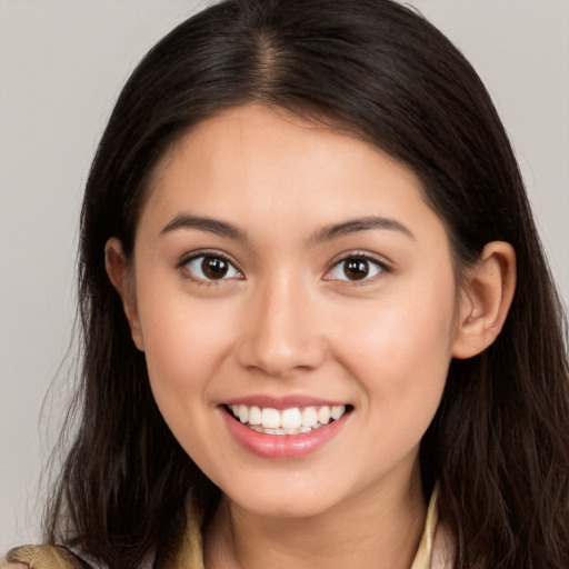 Joyful white young-adult female with long  brown hair and brown eyes