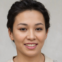 Joyful asian young-adult female with short  brown hair and brown eyes