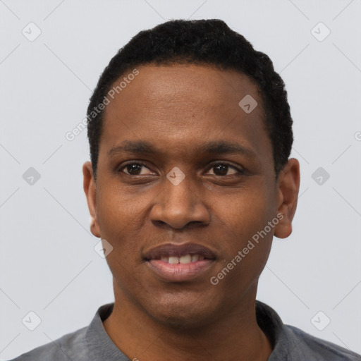Joyful black young-adult male with short  black hair and brown eyes