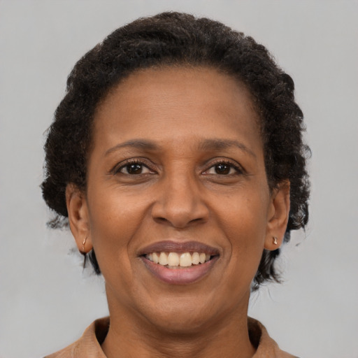 Joyful latino adult female with short  brown hair and brown eyes