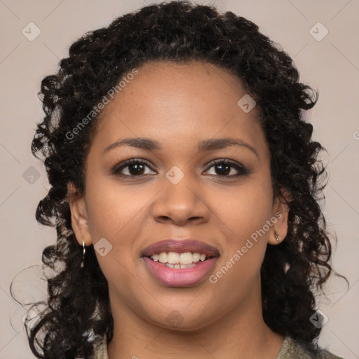 Joyful black young-adult female with long  brown hair and brown eyes