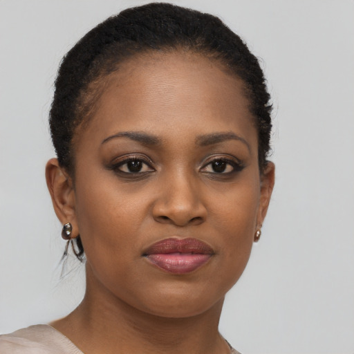 Joyful black young-adult female with short  brown hair and brown eyes