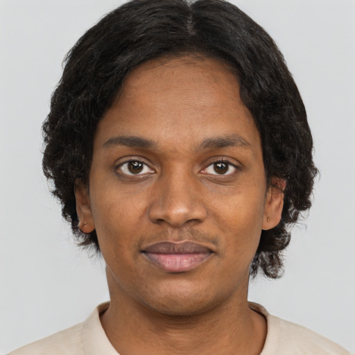 Joyful black young-adult female with short  brown hair and brown eyes