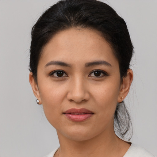 Joyful latino young-adult female with medium  brown hair and brown eyes