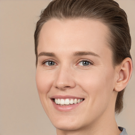 Joyful white young-adult female with medium  brown hair and grey eyes