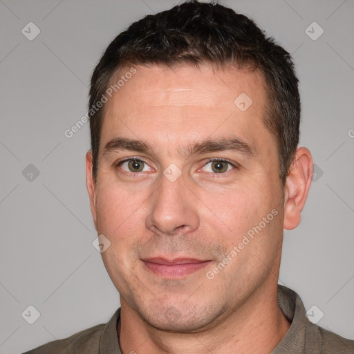 Joyful white adult male with short  brown hair and brown eyes