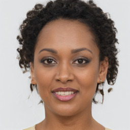 Joyful black young-adult female with medium  brown hair and brown eyes