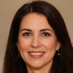 Joyful white adult female with long  brown hair and brown eyes