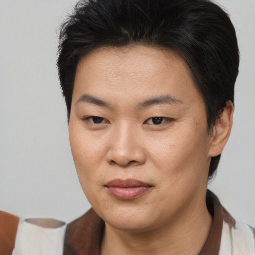 Joyful asian young-adult female with short  brown hair and brown eyes
