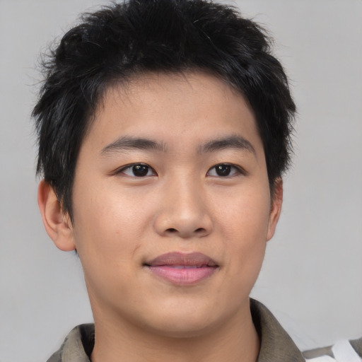 Joyful asian young-adult male with short  brown hair and brown eyes