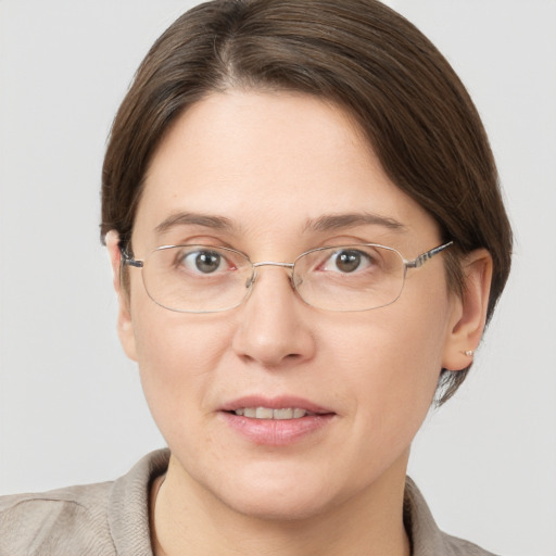 Joyful white adult female with short  brown hair and grey eyes