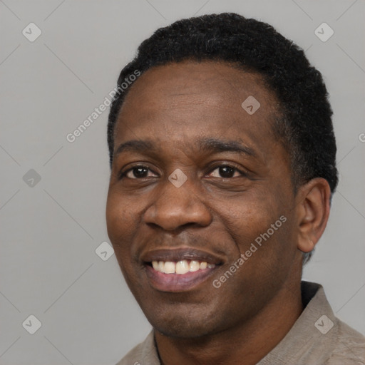 Joyful latino adult male with short  black hair and brown eyes