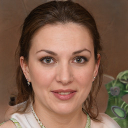 Joyful white adult female with medium  brown hair and brown eyes