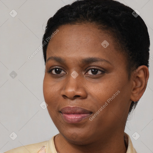 Joyful black young-adult female with short  brown hair and brown eyes