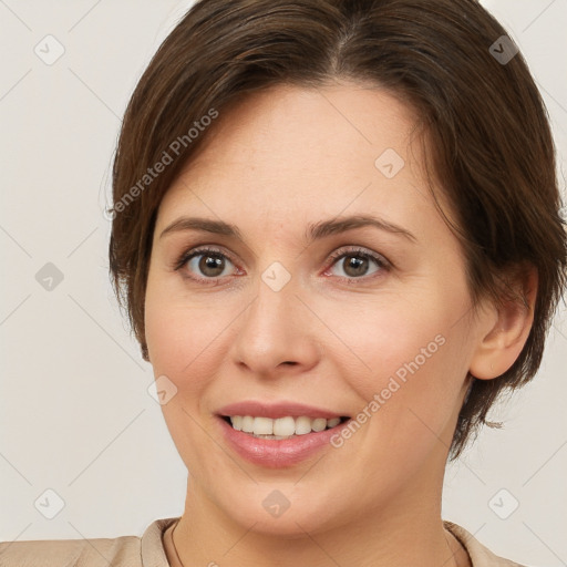 Joyful white young-adult female with short  brown hair and brown eyes