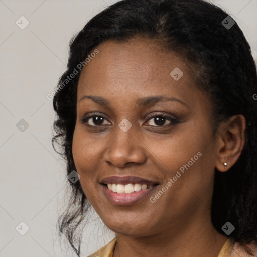 Joyful black young-adult female with long  black hair and brown eyes