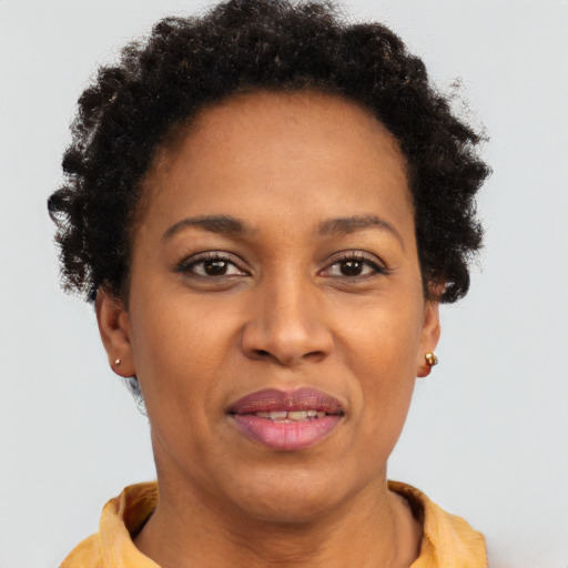 Joyful black adult female with short  brown hair and brown eyes