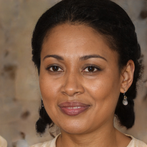 Joyful black adult female with medium  brown hair and brown eyes