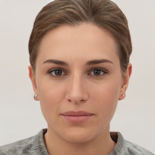 Joyful white young-adult female with short  brown hair and grey eyes