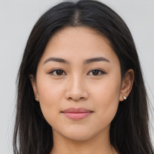 Joyful latino young-adult female with long  brown hair and brown eyes
